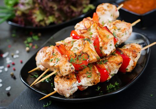 Chicken skewers with slices of sweet peppers and dill. Tasty food. Weekend meal.